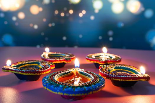 Indian festival Diwali, Diya oil lamps lit on colorful rangoli. Hindu traditional. Happy Deepavali. Copy space for text.