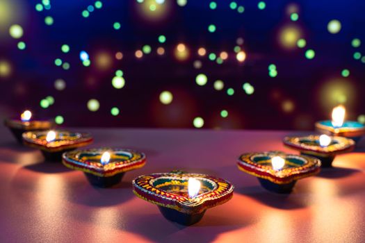 Indian festival Diwali, Diya oil lamps lit on colorful rangoli. Hindu traditional. Happy Deepavali. Copy space for text.