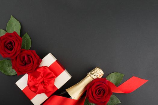 Valentines day composition flat lay top view with gift box rose flowers gift champagne design element on black background with copy space for text