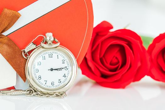 Close up pocket watch and red roses flower with copy space, Valentine'sDay concept