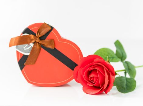 Close up red rose and heart-shaped box on white background, Wedding concept with roses and red heart-shaped box