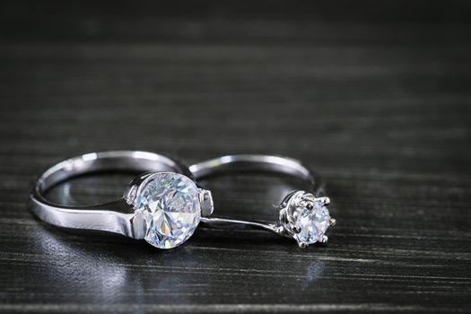 Close up Diamond gem wedding rings on black background