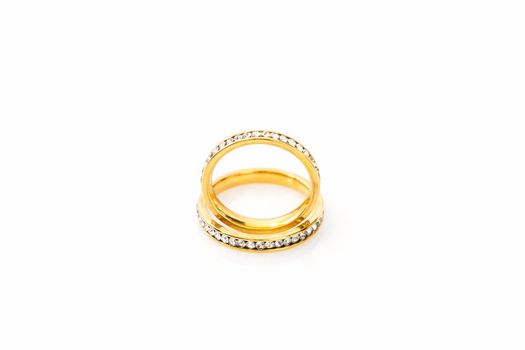 Closeup Gold ring diamond gem. Gold wedding rings with diamond on white background