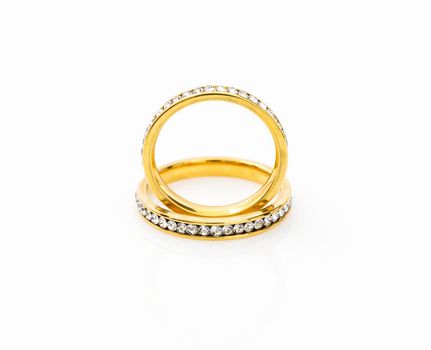 Closeup Gold ring diamond gem. Gold wedding rings with diamond on white background