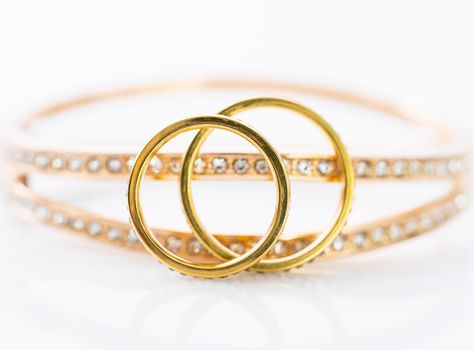 Closeup Gold ring diamond gem. Gold wedding rings with diamond on white background