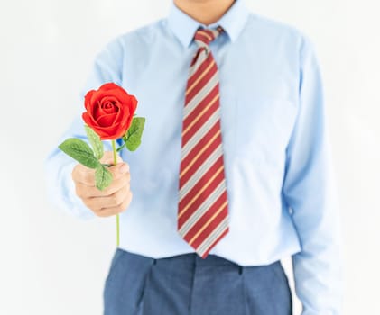 Close up photo of man holding with red rose on white background