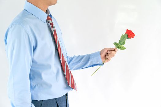 Close up photo of man holding with red rose on white background