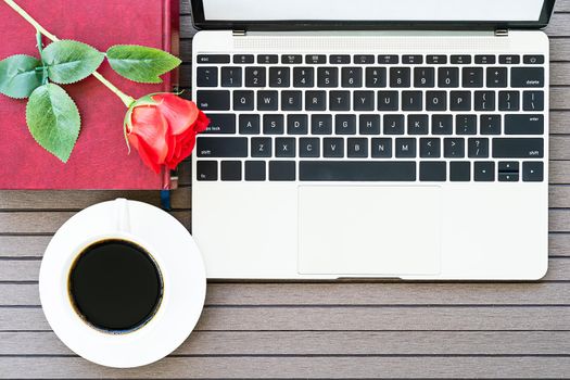 Top view with copy space valentine's day, Office desk table with laptop,notebook, coffee cup,red rose