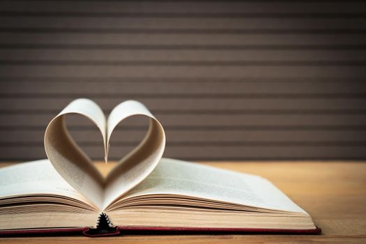 Pages of book curved into a heart shape ,Love concept of heart shape from book pages