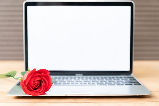 Red rose and laptop mockup on wood background, Valentine concept