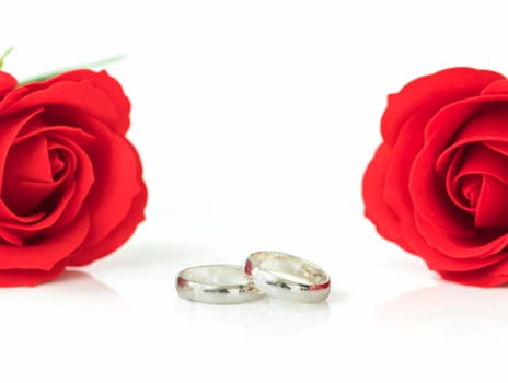 Close up red rose and wedding ring on white background, Wedding concept with roses and ring