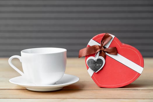 Close up Gift box with coffee cup on wood background,Valentines Day concept with coffee cup and red box