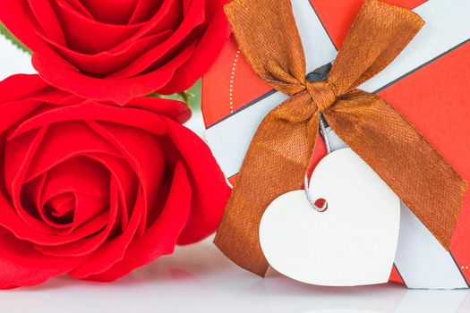 Close up red roses and heart-shaped box ,Valentine's Day concept with roses and red heart-shaped box