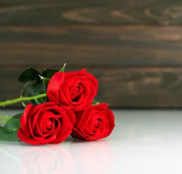 Red roses on table with copy space, Valentine's day background with red roses