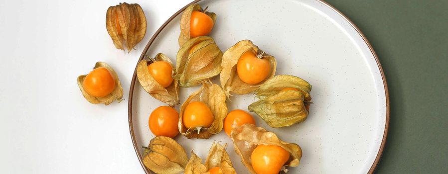 autumn fruits berries, top view. Orange fruit physalis gooseberry in petals. Growing physalis