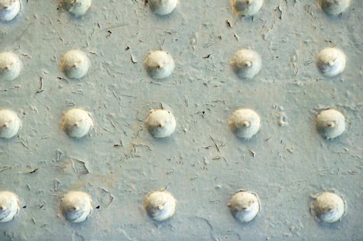 Metal surface with peeling paint with rivets close-up.Texture or background