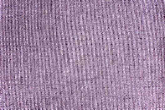 The fabric is purple in color with a textured rough surface close-up.Texture or background