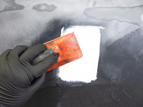 processing of putty with hand tools. technology for repairing paintwork on a car