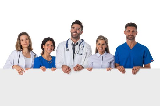 Group of smiling medical doctors with empty banner. Isolated over white background