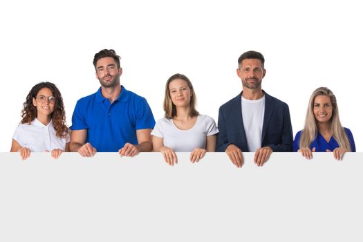 Happy young group of people standing together and holding a blank sign for your text, isolated on white background