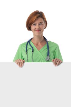 Portrait of a beautiful caucasian readhead doctor nurse with blank banner isolated on white background
