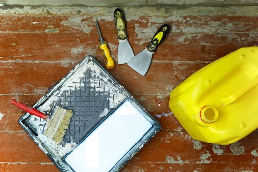 Construction and painting tools lie on the floor during the repair and restoration of the house.Work as a Builder or handyman in the house.Finishing or repairing a room.Job of repairing the apartment                        