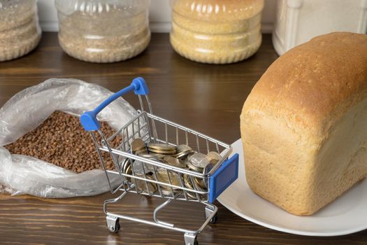 Kazakhstani tenge KZT in a grocery basket with bread, buckwheat grain and cereals. Rising prices for food and groceries in Kazakhstan and other countries. Humanitarian aid.