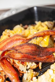 Bacon and scrambled eggs with loaded hashbrowns breakfast meal