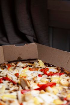 Barbeque chicken, red bell pepper, onion, pineapple pizza in its carryout box