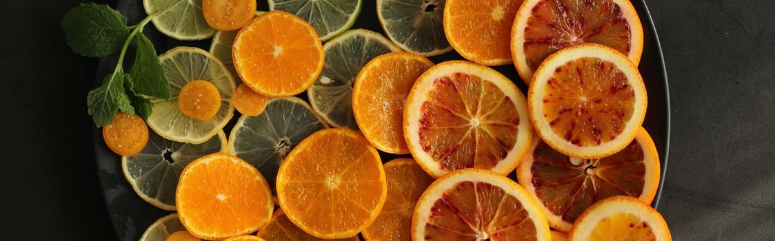 Slices of citrus fruits top view. Horizontal flat lay
