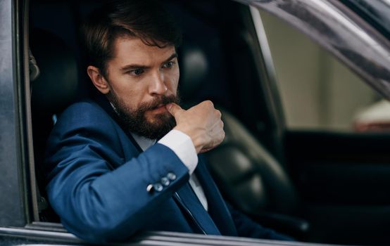 A man in a suit looks out of the window car ride fun lifestyle. High quality photo