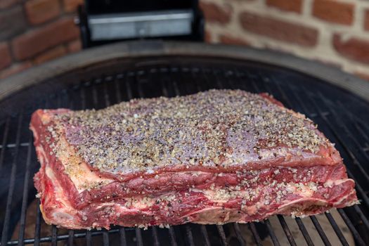 Rubbed brisket beef on grill