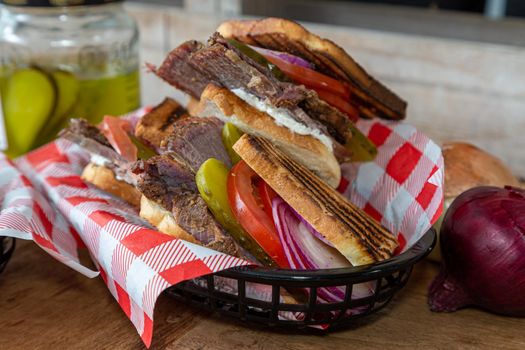 Pastrami sandwich with onions, tomato, cream cheese and pickles