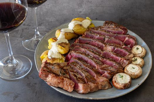 Primerib beef with thyme salt mushrooms on a dish served with wine