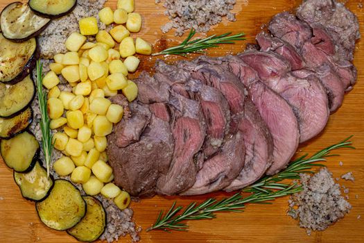 leg of lamb cooked in a salt crust with potato and rosemary
