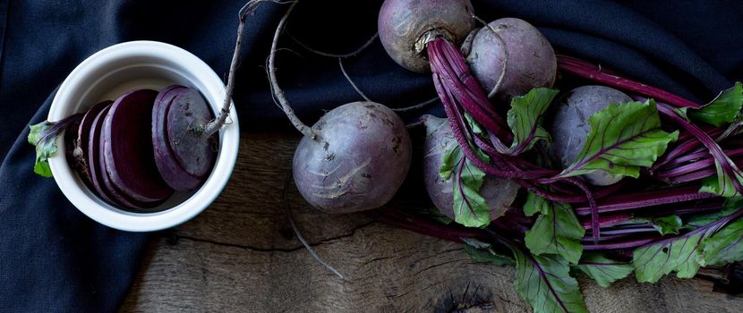 bunch of beetroots on old wood background. Top view. Freshly picked vegetables beetroot