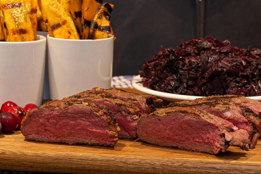 Marinated venison steak with red cabbage and sweet potato fires from the barbecue