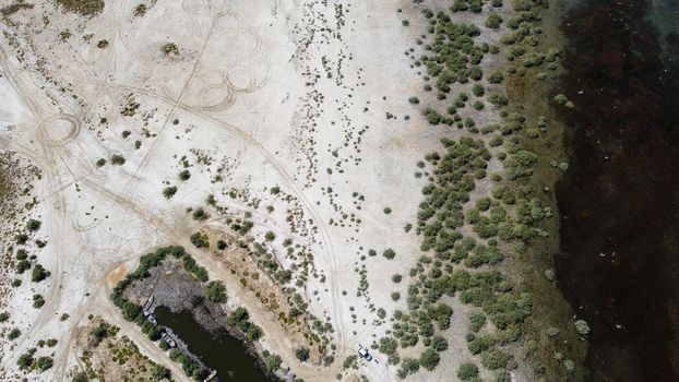 birds eye far drone shoot from a connection of lake - there is wooden boat over there green color is dominant. photo has taken at bafa lake in turkey.