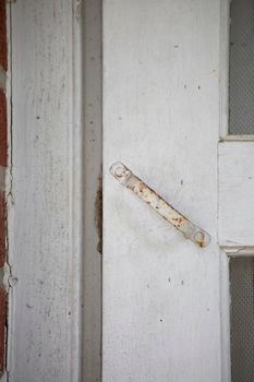 Antique, white handle for a front door screen