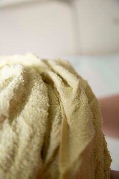 Close up of a damp yellow towel bunched together