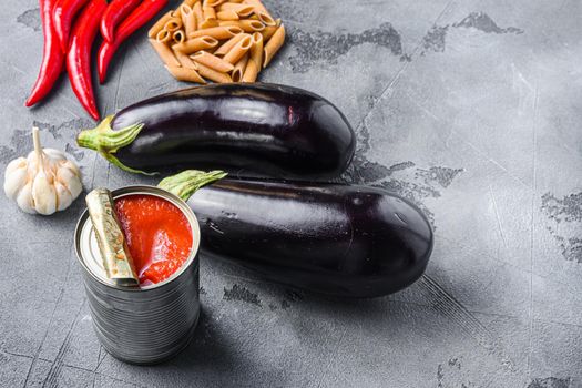 Aubergine penne ingredients eggplant pasta, pepper tomatoe sauce, on grey background side view space for text