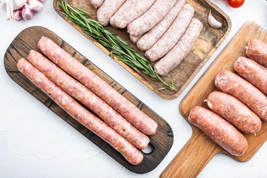 Raw homemade sausages, flat lay, on white background.
