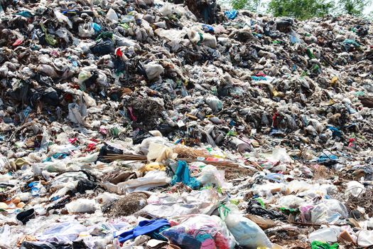 Mountain garbage, large and degraded garbage pile, Pile of stink and toxic residue, waste plastic bottles and other types of plastic waste site in trash dump or landfill. Pollution concept.