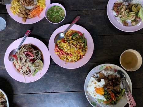 Top view Thai food on table: Eating north eastern foods (SOM TUM - Spicy Papaya Salad, Sticky rice). Local and traditional way. Thai Food Background. enjoy eating concept