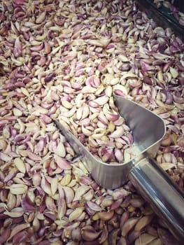 White garlic pile texture. Fresh garlic in market table closeup photo. Vitamin healthy food spice image. Spicy cooking ingredient picture. Pile of white garlic heads. White garlic head heap top view. vintage tone