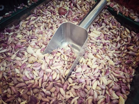 White garlic pile texture. Fresh garlic in market table closeup photo. Vitamin healthy food spice image. Spicy cooking ingredient picture. Pile of white garlic heads. White garlic head heap top view. vintage tone