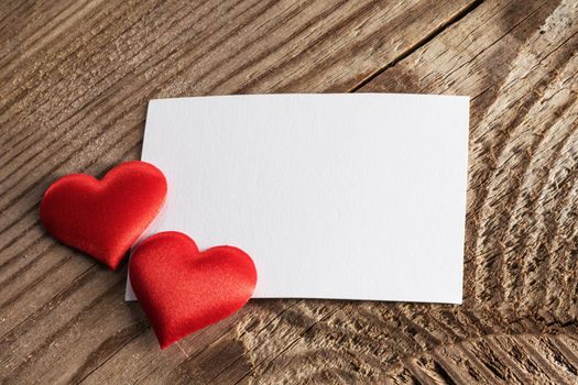 Valentine's day white blank paper greeting card and red silk hearts, background border frame with copy space, love concept