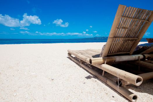 Beach chair made of straw and bamboo at beautiful tropical sea beach