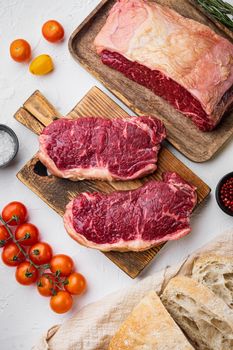 Raw beef steak burger ingredients, with marbled meat, on white background, top view