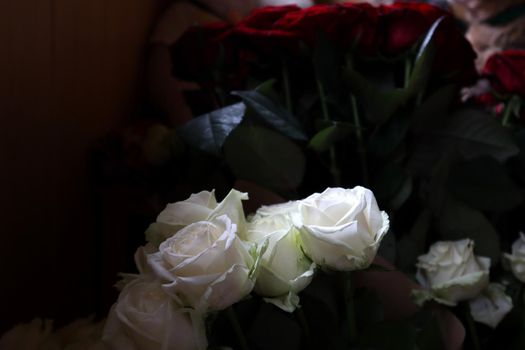 Bouquet of white roses, in the background a bouquet of worm roses